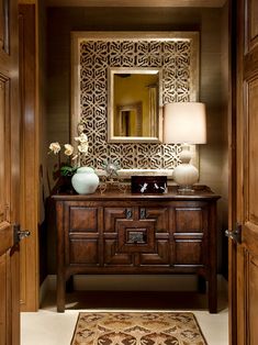 a bathroom with a mirror, sink and rug on the floor in front of it