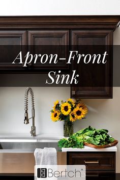 a kitchen sink with sunflowers and greens in the bowl on the counter top