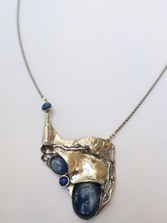 "From Porans collection ----> Unique Silver Pendant, Necklace Kyanite, and Lapis. Description length:55mm width:40mm weight:17.5g The length of the chain is usually 18\"- 22\",  yet can be made at any size you wish, if you are interested in a specific length, Please! write a note on check out Available with many other stones. An amazing gift for yourself or loved ones!  Comes in a beautiful jewelry gift box.  We can also add a personal note in case you would like us to send it as a gift to a lov Unique Silver Necklace With Rectangular Pendant, Handmade Luxury Metal Necklaces, Formal Silver Pendant Custom Necklace, Metal Pendant Necklace With Polished Finish, Handmade Silver Custom Necklace For Formal Events, Polished Metal Pendant Necklace, Unique Necklace With Rectangular Oxidized Pendant, Unique Necklace With Oxidized Rectangular Pendant, Silver Gemstone Pendant Custom Necklace