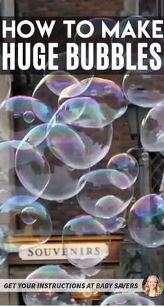 soap bubbles are floating in the air near a sign that says how to make huge bubbles