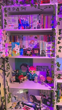 a book shelf filled with lots of books next to a wall covered in purple lights