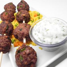 meatballs and rice on a plate with dip