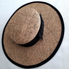 A timeless design hand made natural straw boater style hat with a pleated black wide band. Chic Straw Boater Hat For Garden Party, Elegant Natural Boater Hat For Garden Party, Curved Brim Woven Boater Hat For Kentucky Derby, Elegant Woven Boater Hat For Spring, Classic Woven Wide Brim Boater Hat, Kentucky Derby Woven Boater Hat With Curved Brim, Classic Wide Brim Woven Boater Hat, Chic Black Toquilla Straw Hat, Elegant Flat Crown Sun Hat For Kentucky Derby