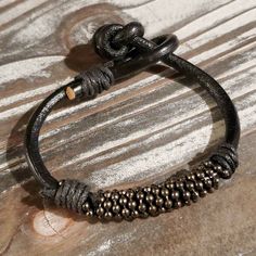 Handcrafted India Thick Black Goat Leather Vintage Gunmetal Beads Bracelethandmade In India From 4mm Thick Goat Leathervegetable Dyed Genuine Leather With Black Waxed Cotton Wrap Accentsweathered Vintage Gunmetal Gray Bali Style Dotted 8mm Diameter Rondelle Beadsprimitive Tribal Style Knotted Claspeach Bracelet Will Vary Slightly In Appearance And Sizeaverage Inner Circumference Is 6.5" To 7" Black Bohemian Leather Bracelet With Round Beads, Bohemian Black Leather Bracelet With Round Beads, Elegant Black Beaded Leather Bracelet, Handmade Metal Leather Bracelet For Everyday Wear, Adjustable Black Leather Bracelet With Round Beads, Adjustable Nickel-free Black Leather Bracelet, Adjustable Black Nickel-free Leather Bracelet, Elegant Leather Beaded Bracelets With Adjustable Fit, Adjustable Metal Bracelets For Everyday