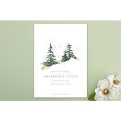 an image of a wedding save the date card with flowers and greenery next to it