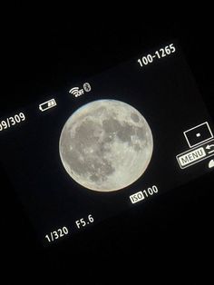 an image of a full moon taken on a cell phone with the time and date displayed