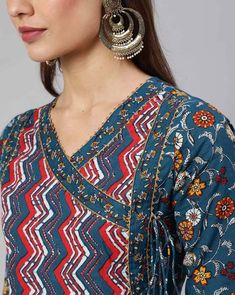 This chic set features a blue ethnic motif print angrakha shape anarkali kurta paired with matching trousers and dupatta offering a blend of elegance and contemporary style. The kurta boasts intricate floral print work that add charm and sophistication, while the trousers complement the ensemble with their coordinated design and printed dupatta. Perfect for both casual outings and special occasions, this set exudes effortless flair and cultural elegance in every detail. No of Sets - 3 Color - Blue Work Done - Ethnic Motif Print Detailing Kurta Fabric - Cotton Kurta Detailing - Angrakha Anarkali shape kurta, round neck with 3/4th Sleeves Trouser Fabric - Cotton Elasticated Waistband Slip on Closure Dupatta Fabric - Cotton Care - Machine Wash Model - 5"8 wearing size small Disclaimer : Sligh Cotton Anarkali Set With V-neck, Bohemian Blue Block Print Anarkali Set, Bohemian Blue Cotton Anarkali Set, Diwali Anarkali Set With Printed Motifs And V-neck, Long Sleeve Anarkali Set With Motifs For Diwali, Navratri V-neck Anarkali Set With Printed Motifs, Diwali V-neck Anarkali Set With Printed Motifs, Blue Kalamkari Print Anarkali Set For Eid, Bohemian Blue Anarkali Set With Kalamkari Print