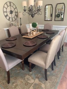 a dinning room table with chairs around it