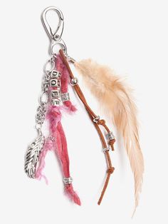 two charms with feathers attached to them on a white surface, one is pink and the other is brown