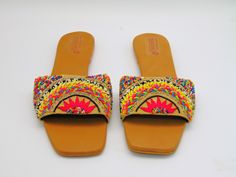 These espadrille like sandals are super cute for the summer, they offer a bright design of floral with leaves to add. These also have a beaded design on some of the flowers and leaves. They are also super comfy with a comfortable sole to walk in all day. These would be cute for a picnic or a photoshoot. Don't miss out on these cute sandals! See our page for more of our collection of shoes we offer. We ship out in a timely matter, wrapped in care for a safe secure trip to your location. Thank you Spring Bohemian Flats With Round Toe, Bohemian Spring Flats With Round Toe, Bohemian Round Toe Flats For Spring, Embellished Summer Beach Sandals, Floral Print Sandals For Beach Season, Embroidered Summer Flats, Bohemian Slip-on Sandals For Spring, Trendy Floral Print Beach Sandals, Summer Floral Print Beach Sandals