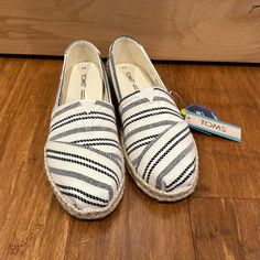 Toms Shoes Alpargata Rope, Natiral Global Stripe Spring White Textile Espadrilles, White Textile Espadrilles With Round Toe, White Textile Slip-on Espadrilles, Trendy White Slip-on Espadrilles, White Sneakers For Spring Vacation, White Synthetic Espadrilles With Flat Heel, White Synthetic Slip-on Espadrilles, Trendy White Round Toe Espadrilles, Casual White Flats With Woven Sole