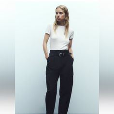 High-Waisted Pants With Front Pleats. Front Pockets And Side Flap Patch Pockets. Adjustable Hem With Button. Front Zip, Metal Hook, And Interior Button Closure. Belt With Buckle And Metal Studs. Versatile Cargo Pants With Belt Loops For Workwear, Chic Cargo Pants With Belt Loops, Chic Workwear Cargo Trousers, Chic Cargo Trousers For Workwear, Chic High-waisted Cargo Pants For Business Casual, Casual Office Bottoms By Zara, Chic High-waisted Cargo Pants For Work, Zara Casual Office Bottoms, High-waisted Cargo Pants With Belt Loops For Business Casual