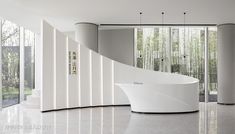 a large white bath tub sitting in the middle of a room next to tall windows