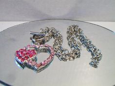 Pink double heart necklace. It measures approx. 19 inches and has a toggle clasp closure. Made with a light pink rhinestone heart silhouette and a smaller solid hot pink rhinestone heart. Silver tone. Perfect for give or wear on Valentine's Day. All sales are final and as is. Thank you for looking. You may also love this: https://www.etsy.com/listing/584789387/heart-silhouette-pendant-necklace?ref=shop_home_active_1 Valentines Day Costume, Pink Heart Pendant, Heart Silhouette, Double Heart Necklace, Carnelian Ring, Rhinestone Heart, Double Heart, Lovely Necklace, Lovely Earrings