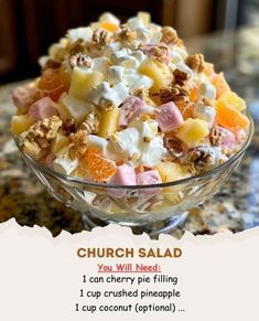 a bowl filled with fruit and nuts on top of a counter next to a menu