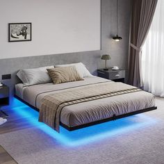 a large bed with blue lights underneath it