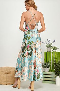 Expertly crafted with a floral print, this satin slip dress features an elegant open back design. The refreshing mint color adds a touch of allure to any occasion. Perfect for those looking for a stylish and sophisticated look. The satin material drapes gracefully, ensuring a flattering silhouette that flows with every step. Elevate your wardrobe with this statement piece that seamlessly combines the allure of florals with the timeless appeal of a satin slip dress. Step into the spotlight with c Satin Maxi Dress With Tie Back, Satin Spaghetti Strap Dress For Garden Party, Spring Backless Satin Dress, Feminine Floral Print Satin Dress, Backless Satin Dress For Spring, Chic Floral Print Backless Slip Dress, Satin Spaghetti Strap Vacation Dress, Satin Spaghetti Strap Dress For Vacation, Spring Chic Backless Satin Dress