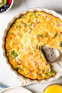 a quiche with broccoli and cheese in a pie pan on a table