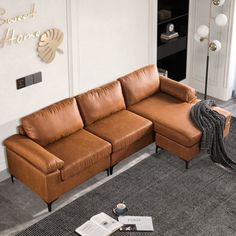 a brown leather couch sitting on top of a carpeted floor