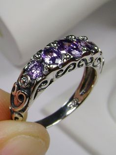 Purple Amethyst Cubic Zirconia Ring  Georgian Design#19 MADE TO ORDER Inspired by Georgian and Edwardian designs I now offer this stunning Antique reproduction in sterling silver. This gorgeous ring is set with flawless purple amethyst cubic zirconia gems (Natural Amethyst also available). The 5 stunning full cut purple CZs array the gorgeous setting which is 6mm NS on the finger; the gems are approximately 2ctw. The inside of the band is marked 925 for sterling silver. Notice the beautiful craf Georgian Ring, Victorian Filigree, Stock Design, Purple Amethyst Ring, Amethyst Gem, Purple Band, Cz Ring, Victorian Jewelry, Silver Filigree