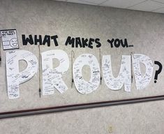 a wall with writing on it that says what makes you proud?