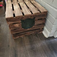 a wooden crate sitting on top of a hard wood floor