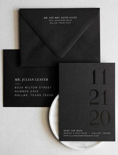 two black and white business cards on top of each other next to an envelope with the numbers