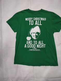 Gently used cool Clark Griswold Merry Christmas T-shirt Green Short Sleeve Christmas Tops, Christmas Cotton Graphic Print T-shirt, Holiday Green T-shirt With Letter Print, Christmas Cotton Top With Screen Print, Christmas Cotton Tops With Screen Print, Winter Green Graphic Print T-shirt, Green Cotton T-shirt For Holiday, Green Graphic Print T-shirt For Winter, Green Christmas Crew Neck T-shirt