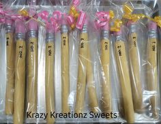 six wooden candles wrapped in plastic and tied with pink ribbon, labeled krazy keratonz sweets