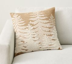 a white couch with a decorative pillow on it