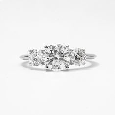 three stone diamond ring on white background