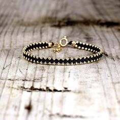 This bracelet uses the same technique as the old friendship bracelets we've all come to know and love, but with a bit of a twist.  14K Gold Filled beads and clasp hand knotted using natural jewelry linen thread. The bracelet is adjustable 15.5cm to 18.5cm long. (6.1-7.3Inches) Gold Filled is by no means gold plated. It is a much thicker layer of gold that is welded to the bottom brass layer and therefore lasts much longer (can last a life time, depending on wear).  Can be gift wrapped just let m Hand-strung Friendship Bracelet Jewelry, Hand-strung Friendship Bracelet, Gold Braided Bracelet With Tiny Beads As Gift, Everyday Gold Beaded Braided Bracelets, Gold Spiritual Beaded Bracelets, Friendship Bangle Jewelry With Tiny Beads, Adjustable Gold Hand Wrapped Rosary Bracelet, Spiritual Gold Beaded Bracelets, Adjustable Gold Jubilee Friendship Bracelet