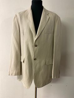 Add a touch of sophistication to your wardrobe with this men's linen jacket. The classic 90s blazer style and off-white color make this piece perfect for a summer wedding or any formal event.  Men's Vintage blazer circa 1990. Off-white linen blazer made by Biangini, made in Italy.  This dress jacket has notched narrow lapels, a 2-button front closure, 4-button cuff embellishment,  a faux breast pocket, faux front hip pockets with flaps, and 2 inside pockets. The back has a center vent and is ful Cream Sport Coat For Spring Formal, Spring Formal Cream Sport Coat, Vintage Single-breasted Linen Blazer, Vintage Linen Single-breasted Blazer, Classic Cotton Sport Coat For Spring, Classic Linen Sport Coat For Business Casual, Classic Linen Blazer With Button Closure, Classic Long Sleeve Linen Sport Coat, Classic Spring Cotton Sport Coat