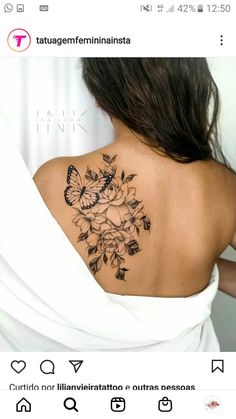 the back of a woman's shoulder with flowers and butterflies on it