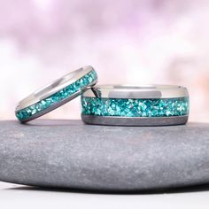 two wedding bands with blue glitter on them