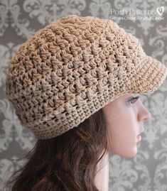 a woman wearing a crocheted hat on top of a mannequin head