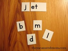 the word jet b m d spelled with cut out letters on a wooden surface