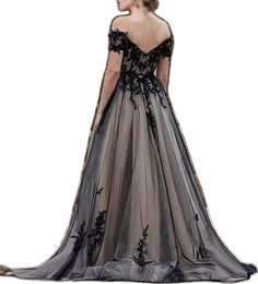 the back of a woman's dress in grey and black with floral appliques