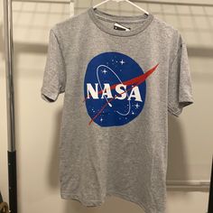 a nasa t - shirt hanging on a clothes rack