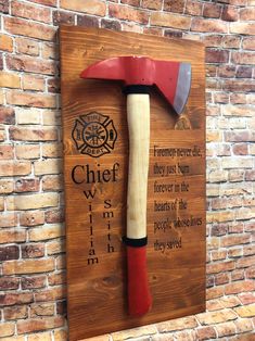 "Firemen never die they burn in our hearts forever! This is an amazing Fireman's gift.This is a well crafted piece that is perfect for giving to the firemen who run into danger to save those in need. This wooden sign is perfect as gift for the firehouse, someone becoming a new fireman or retiring from the fire department. The cherry wood stained board is approx. 20\" tall and 12\" wide and is drilled to hold the 20\" fireman's axe. These do come with the black cover for the axe which can be remo Fire Hose Crafts, Fire Dept Decor, Fire Department Decor, Firefighter Room, Cherry Wood Stain, Fire Ideas, Scouts Bsa, Firefighter Decor, Cnc Ideas