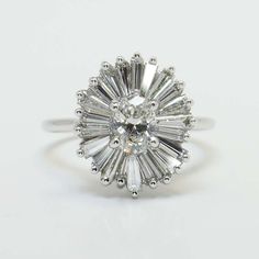 Flower Ring with Tapered Baguette Side Stones Ballerina Engagement Ring, Floral Wedding Ring, Oval Cut Diamond Rings, Art Deco Flower, Flower Engagement, Floral Halo, Luxury Vehicles, Oval Diamond Ring, Flower Engagement Ring