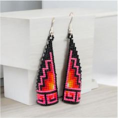 New Native American handmade  beaded dangle earrings with vibrant pink, black, and red beads.  Hang approximately 2" long. By Navajo artist Denise Goldtooth. These earrings are a celebration of vibrant color and traditional craftsmanship, featuring a harmonious blend of pink, black, and red beads that come together to form a captivating design. Each bead is meticulously handwoven, showcasing Denise's dedication to her craft and her deep-rooted connection to her Navajo heritage. Measuring approximately 2 inches in length, these earrings offer a perfect balance of elegance and statement-making style. Their lightweight design ensures comfortable wear, while the vivid colors add a striking accent to any outfit, making them ideal for both everyday wear and special occasions. Whether you're look Unique Black Beaded Dangle Earrings, Unique Pink Beaded Dangle Earrings, Unique Pink Dangle Beaded Earrings, Unique Handmade Black Beaded Earrings, Black Beaded Earrings For Festival, Unique Handmade Pink Beaded Earrings, Unique Black Beaded Earrings With Dangling Beads, Black Beaded Earrings With Ear Wire For Festival, Black Beaded Drop Earrings With Large Beads