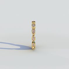 an image of a gold ring with three stones on it's sides and one stone in the middle