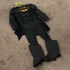 a batman costume is laying on the floor