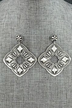 "These beautifully crafted sterling silver earrings were made by Navajo silversmith Lane Tahe. The backs are signed and stamped sterling. Length: 2 3/8\" Width: 1 7/8\" Free shipping on all orders! We ship with USPS and always include tracking. All orders ship within a day of payment. Returns are accepted up to 30 days after you receive your order. Just send us a message. Our shop offers cash back or store credit. The item must be returned in new condition." Stamped Dangle Jewelry, Artisan Sterling Silver Etched Earrings, Artisan Etched Sterling Silver Earrings, Artisan Stamped 925 Earrings, Silver Concho Drop Earrings, Silver Concho Dangle Earrings, Silver Dangle Earrings With Concho, Decorative Silver Earrings As Gift, Silver Concho Earrings As A Gift