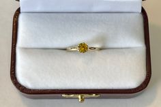 Lovely vintage 14K yellow gold ring featuring a beautiful yellow Sapphire . The gemstone is a bright yellow, round cut, and weighs an estimated .46 carats. The setting is lovely, 6 prong raised ring head. Stunning piece of fine Mid-Century era jewelry with September birthstone, circa 1960. ERA - Circa 1960s METAL / MATERIAL - 14k yellow gold, 1 Yellow Sapphire [estimated .46 carats] MARKINGS / HISTORY - 14k with a Crown CONDITION - Good vintage condition. Yellow sapphire is secure in setting and Yellow Sapphire Ring With Center Stone In Yellow Gold, Yellow Sapphire Ring With Center Stone, Fine Jewelry Citrine Diamond Ring In Round Cut, Fine Jewelry Citrine Diamond Ring Round Cut, Yellow Gold Topaz Ring With Yellow Sapphire Center Stone, Fine Jewelry Citrine Ring With Round Cut, Yellow Sapphire Ring With Brilliant Cut, Oval Yellow Sapphire Rings With Brilliant Cut, Oval Brilliant Cut Yellow Sapphire Rings