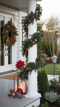 christmas wreaths are hanging on the pillar outside