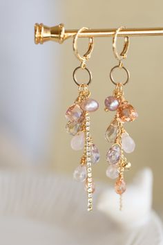 "This beautiful earrings are made from handful of gemstone like Quartz, Amethyst, Amtrine, Rose Quartz, and Pearl in 14K gold filled wires. They are carefully hung on a ring that dangling under a small gold ear hoop. The pictures do not do this earrings justice Let this unique accessory be your everyday adventures or a great gift for the loved one! Because each item is handmade there may be differences from the picture viewed. Each stone/ piece is unique and no two pieces will be exactly alike. Small Gemstone Jewelry, Handmade Stone Earrings, Delicate 14k Gold Filled Briolette Earrings, Delicate Briolette 14k Gold Filled Earrings, Bead Earrings Ideas, Earring Cluster, Rose Quartz And Pearl, Diy Earrings Dangle, Hoop Earrings Diy