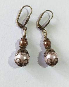 Victorian rose pearl bronze earrings bohemian earrings Boho pearl earrings vintage earrings antique earrings gift earrings wedding earrings Beautiful Victorian style earrings made of crystal rose and brown pearls beads and bronze-tone filigree ornaments . Victorian filigree earrings .  Bronze beautiful Boho earrings. Bohemian earrings . Victorian style bronze-tone rose and brown crystal pearl beads dangle earrings and necklace . Romantic jewelry set pearls earrings . Bridal jewelry set. Wedding Elegant Beaded Copper Jewelry, Vintage Gold Beaded Earrings, Elegant Metal Beaded Earrings With Round Beads, Elegant Round Beaded Metal Earrings, Elegant Brown Dangle Earrings, Elegant Beaded Bronze Jewelry, Antique Gold Copper Drop Earrings, Vintage Rose Gold Round Earrings, Elegant Bronze Beaded Jewelry