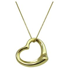 TIFFANY & Co. Elsa Peretti 18K Gold 27mm Open Heart Pendant Necklace Metal: 18K Yellow Gold Weight: 9.70 grams Pendant: 27mm wide Chain: 18" Hallmark: TIFFANY&Co. © Elsa Peretti 750 SPAIN Condition: New, comes with Tiffany pouch, box and ribbon bow Tiffany price: $4,100 Authenticity Guaranteed Elsa Peretti, Tiffany And Co, Open Heart, Metal Necklaces, Ribbon Bow, Heart Pendant Necklace, Ribbon Bows, Tiffany & Co., Heart Pendant